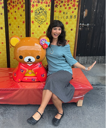 Lang standing next to a Rilakkuma statue